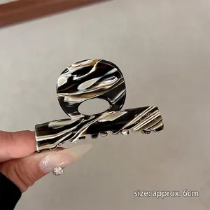 Close-up of tortoise shell acetate hair claw with size mark 6cm for fringe styling