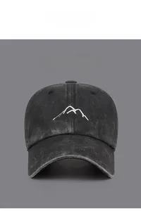Close-up of vintage washed cotton baseball cap featuring mountain peak embroidery detail