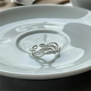 Macro detail of intertwined 925 sterling silver ring with twisted texture and open band