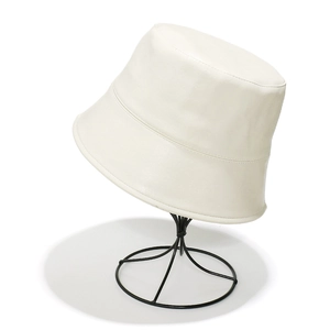 Close-up of premium white PU leather bucket hat showing fine stitching and smooth texture