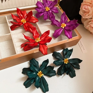 Three-color oversized acrylic floral earrings in red, purple, and dark green displayed in a box