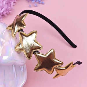 Detail of a black headband featuring shiny gold stars and metallic stitched textures