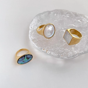 Minimalist gold rings with white mother-of-pearl and iridescent abalone shell insets