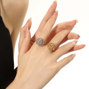 Detailed view of intertwined hollow round patterns on gold and silver snake rings