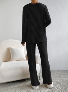Detail of black ribbed knit lounge set featuring back view of sweater and trousers