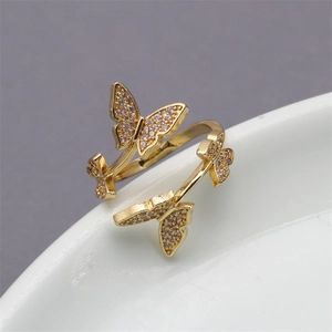 Adjustable gold butterfly open ring with micro-paved zircons on white ceramic base
