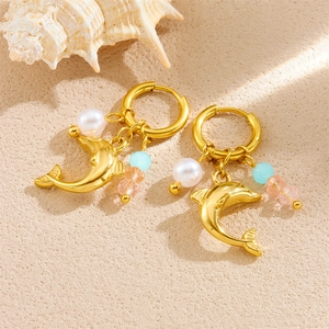 Golden dolphin charm earrings with pearl and colorful beads on a sandy beach ocean theme