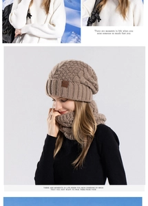Detailed knit texture of winter camel beanie and neck gaiter set with leather logo