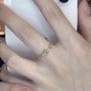 Minimalist gold open ring featuring an oval cat-eye stone and yellow accent diamonds