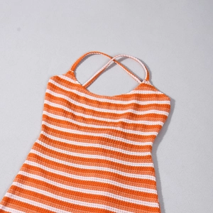 Close-up of orange and white striped knit fabric and crisscross back straps