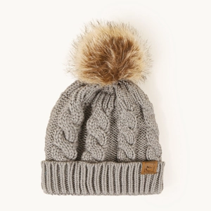 Detailed knit texture and brown faux fur pom-pom on a gray winter beanie hat