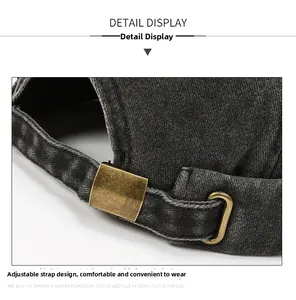 Detail view of washed denim docker hat showing adjustable bronze metal buckle and strap