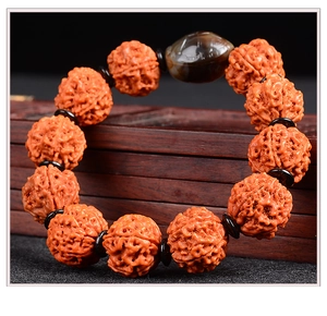 Close-up of five-petal Rudraksha beads with deep texture on a red wooden gift box