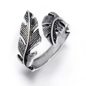 Close-up of vintage silver feather ring showing oxidized textures and open adjustable design