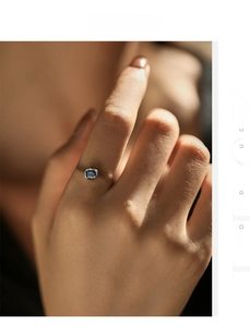 Close-up of S925 silver twist band ring featuring a heart-shaped blue sapphire gemstone
