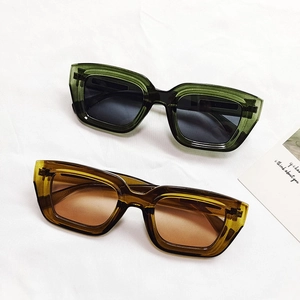 Retro oversized square cat eye sunglasses in transparent green and amber frames