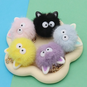 Furry colorful plush coal ball keychains in pink, black, grey, yellow and purple