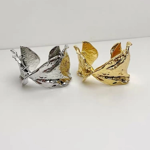 Minimalist twisted metal bangle with crinkled texture in gold and silver finish