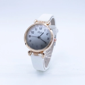 Detail view of quartz watch with white leather strap and gradient numeric dial