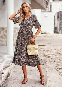 Detail of V-neck floral midi dress in black with colorful print for summer vacation