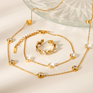 Detail of 18K gold plated stainless steel necklace and ring set with zircon stones