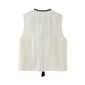 Back view of white sleeveless tank top with fringe tassel and black embroidery trim