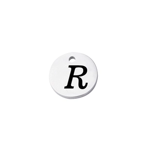 Macro shot of mirror-finish stainless steel round tag featuring an engraved letter R