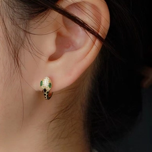 Golden S925 silver snake earrings with green gemstones and sparkling cubic zirconia