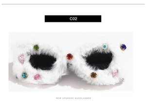 Close-up of white cat-eye sunglasses with plush fur trim and multicolor rhinestones