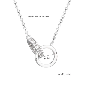 Macro detail of interlocking rings with micro-paved crystals on silver chain necklace