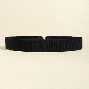 Close-up of black elastic cinch belt featuring a textured weave and bronze metal buckle