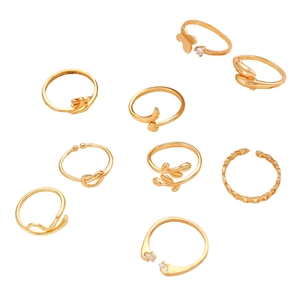 Detail of 9-piece gold adjustable ring set featuring butterfly, dolphin and leaf designs