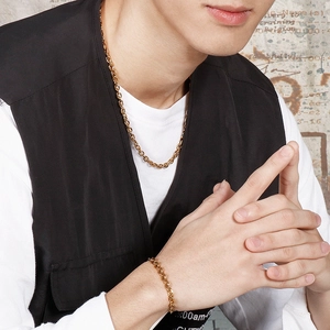 Minimalist gold stainless steel link chain necklace and bracelet set on male model