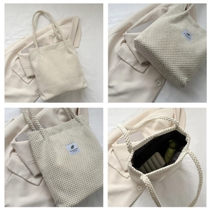 Detail of corduroy tote bag interior with magnetic snap and various daily essentials
