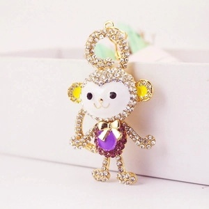 Golden monkey keychain featuring crystal rhinestones and purple sparkling stones