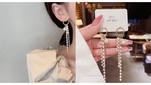 Close-up of long pearl tassel earrings with 925 silver needles and golden circle design