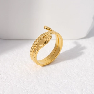 Close-up of golden adjustable snake ring with detailed scale texture and wrap-around design