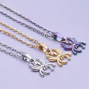 Three minimalist spider necklaces in silver, gold, and multicolor on light purple background