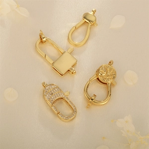 Set of four gold-plated heart and spring clasps with zircons for jewelry making