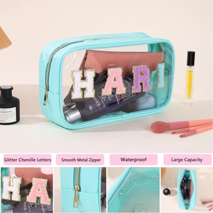 Detailed view of mint green PVC toiletry bag with HARI chenille gold letter embroidery