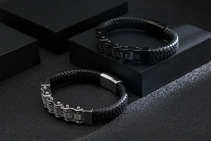 Detail of black leather punk bracelets with silver and black steel motorcycle chains