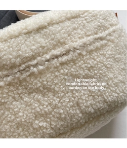 Close-up of white plush faux fur fabric texture for lightweight crossbody bag