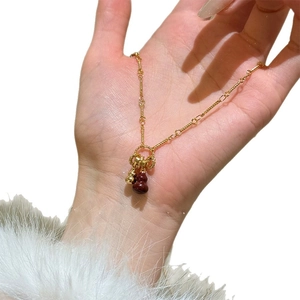 Elegant gold plated necklace with double gourd pendants in gold and reddish-brown stone
