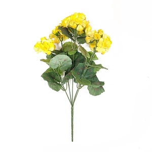 Detailed view of artificial yellow geranium bouquet with silk petals and green leaves