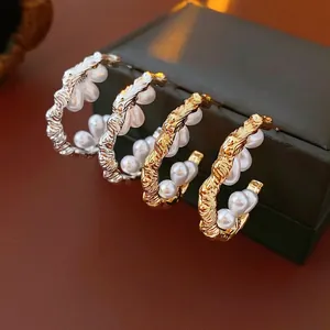 Chic twisted C-shaped pearl earrings in gold and silver finish with retro style