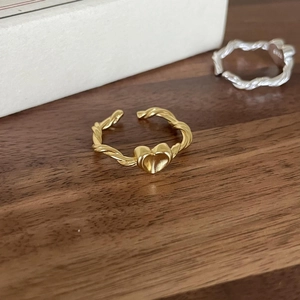 Detail of gold heart open ring with twisted rope texture and adjustable band
