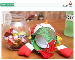 Close-up of a Christmas snowman candy jar with red knit hat and festive green scarf