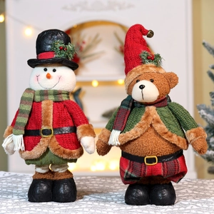Detail of Christmas snowman and bear plush dolls with knitted outfits and faux fur trim