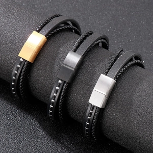 Detailed macro view of woven leather bracelets with gold, black, and silver magnetic clasps