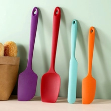 Detailed view of four silicone spatulas in various colors and sizes for cooking